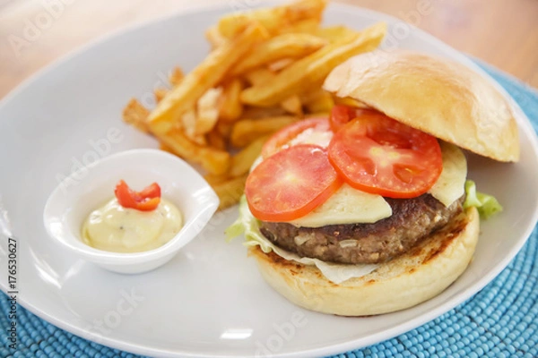 Obraz Hamburger and fries served on the restaurant table