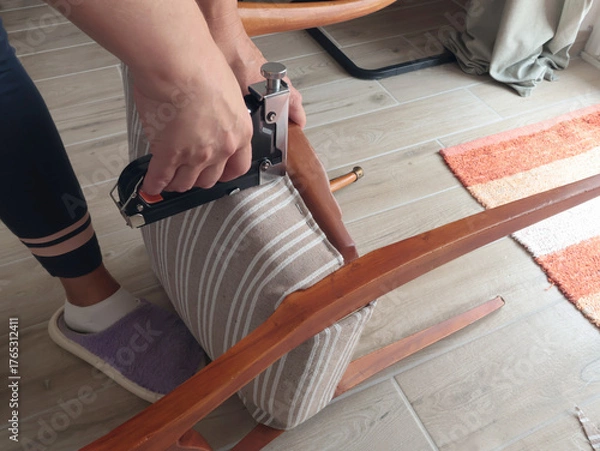 Obraz Anonymous person restore old vintage chair in home. Fabric replacement. Antique furniture and modern striped linen and cotton fabric. Hobbies, crafts, and retro-minimalist style.