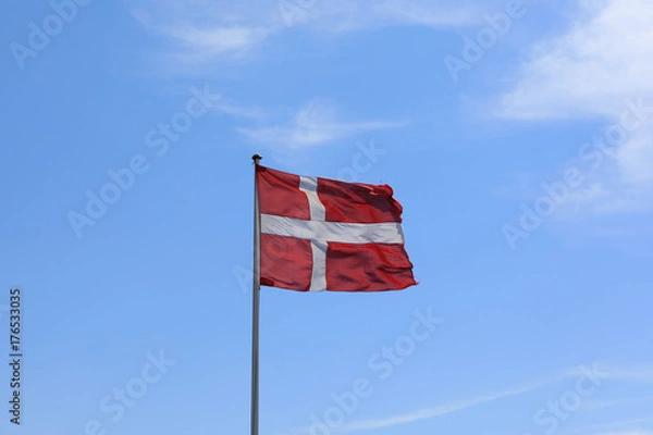 Fototapeta The Danish flag weaves in the wind.