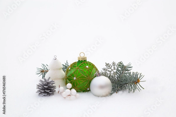 Fototapeta Christmas decorations and fir branches in fluffy snow. Copy space