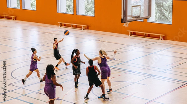 Obraz Female basketball players playing an intensive game in a dynamic indoor court