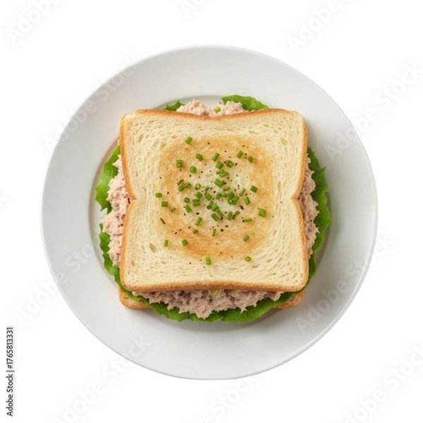 Obraz Elevated view of a classic tuna salad sandwich on a white plate against black backdrop