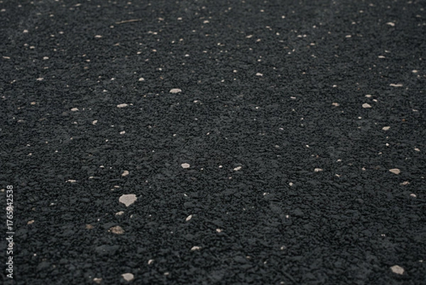 Fototapeta Black rubber flooring surface texture background with white specks for gym playground safety surface