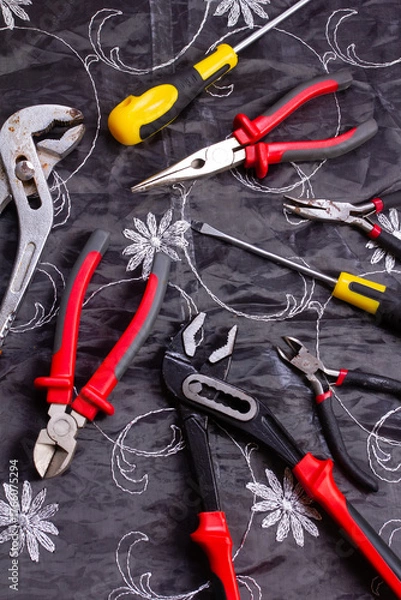 Obraz  locksmith tools on an embroidered tablecloth
