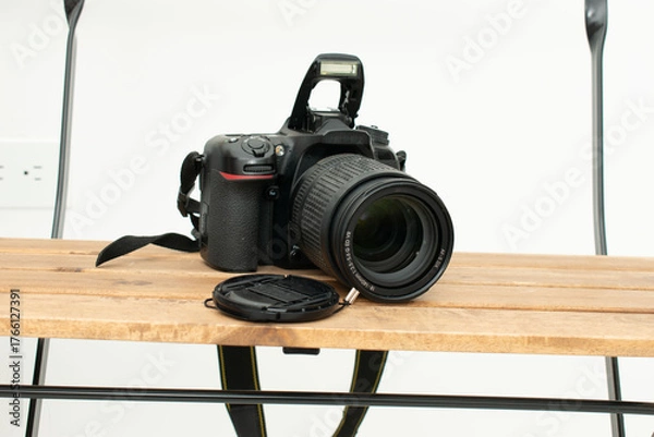 Obraz Black DSLR camera with lens cap