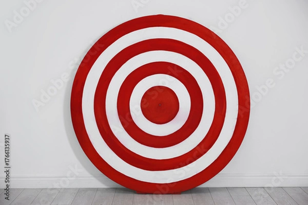 Fototapeta Round shooting target on floor near white wall