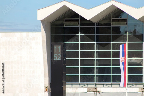 Fototapeta Editorial photo of the Novi Sad railway station clock showing 11:52, captured on October 23, 2025, shortly before the first anniversary of the 2024 tragedy.