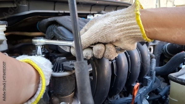 Obraz mechanic changing car engine