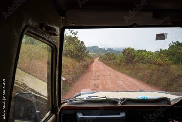 Fototapeta Driving View from Inside a 4x4 Vehicle on a Remote Dirt Road Through the Jungle in Africa