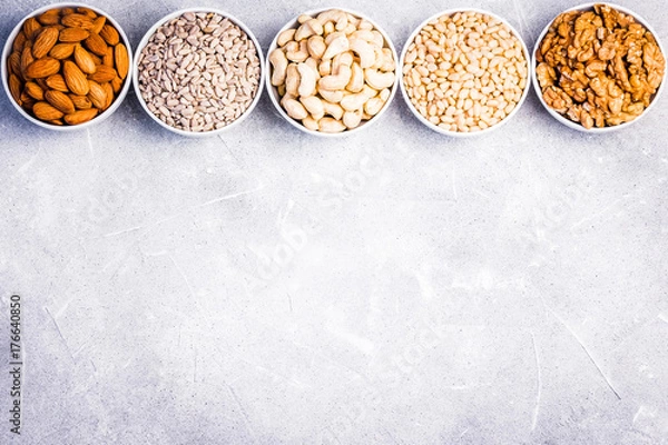Fototapeta Nuts and seeds mix on concrete background. Top view, space for text.