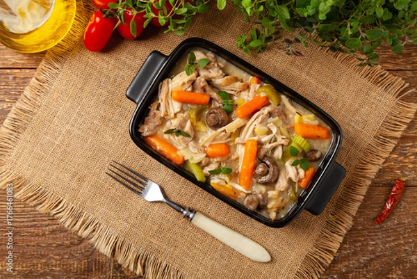 Obraz Chicken casserole. Served in black pots.