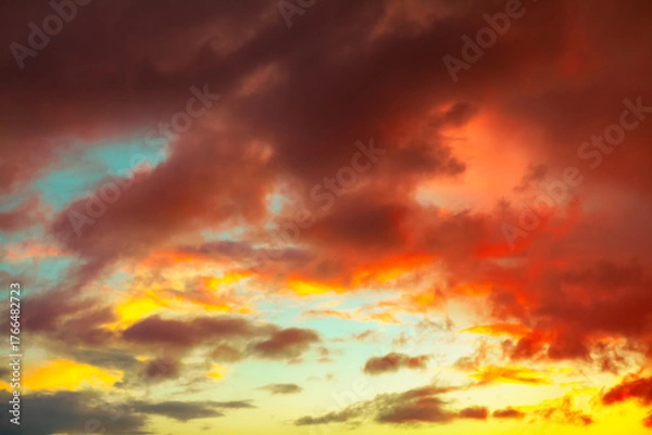 Obraz Dramatic sunset sky swirls with deep in fiery orange clouds. Ethereal glow evokes a fiery, apocalyptic beauty over the horizon