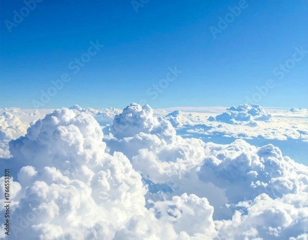 Fototapeta Aerial view of fluffy white cumulonimbus clouds against a bright blue sky