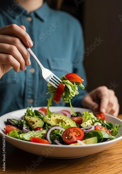 Fototapeta Eating Healthy Salad with Avocado Tomato and Red Onion for Wellness