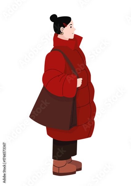 Fototapeta Young woman in red winter coat with brown shoulder bag and boots standing in profile isolated on white background