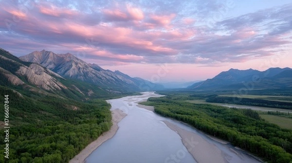 Obraz Dramatic Aerial Landscape of a Winding River Valley Surrounded by Majestic Mountains Under a Soft Pink and Blue Sunset Sky with Wispy Clouds