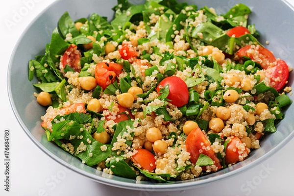 Fototapeta Dietary menu. Healthy vegan salad of fresh vegetables - tomatoes, chickpeas, spinach and quinoa in a bowl.