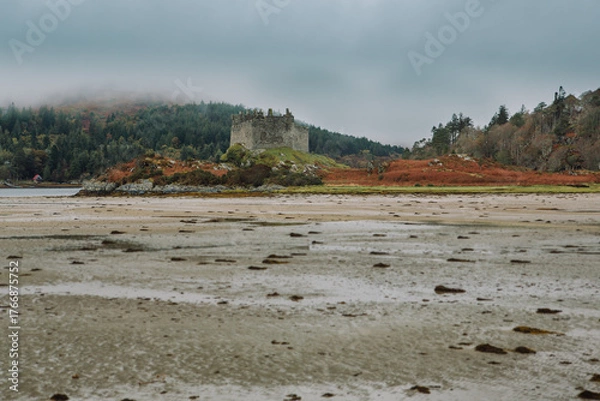 Fototapeta A dramatic and atmospheric photograph of the ruined medieval Castle Tioram (pronounced "Cheerum"), the former stronghold of the Clanranald branch of the MacDonalds - in Loch Moidart