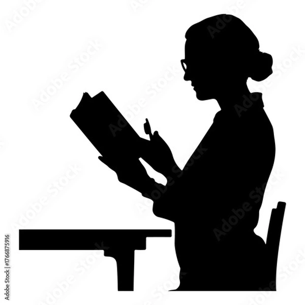 Fototapeta Silhouette of a woman wearing glasses reading a book at a desk with a chair in a studio setting