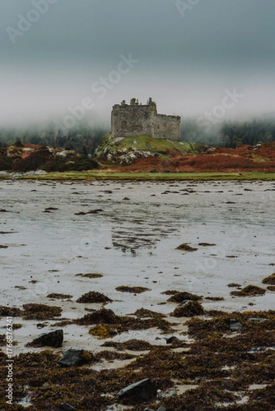 Fototapeta A dramatic and atmospheric photograph of the ruined medieval Castle Tioram (pronounced "Cheerum"), the former stronghold of the Clanranald branch of the MacDonalds - in Loch Moidart