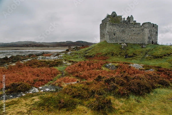 Fototapeta A dramatic and atmospheric photograph of the ruined medieval Castle Tioram (pronounced "Cheerum"), the former stronghold of the Clanranald branch of the MacDonalds - in Loch Moidart