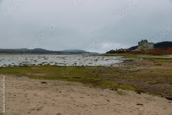 Fototapeta A dramatic and atmospheric photograph of the ruined medieval Castle Tioram (pronounced "Cheerum"), the former stronghold of the Clanranald branch of the MacDonalds - in Loch Moidart
