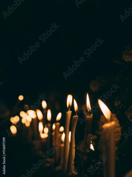 Obraz Many burning candles light in dark night