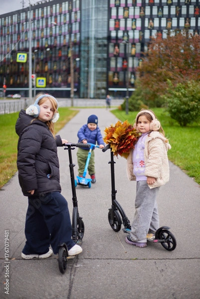 Fototapeta Kids enjoy autumn day in the park