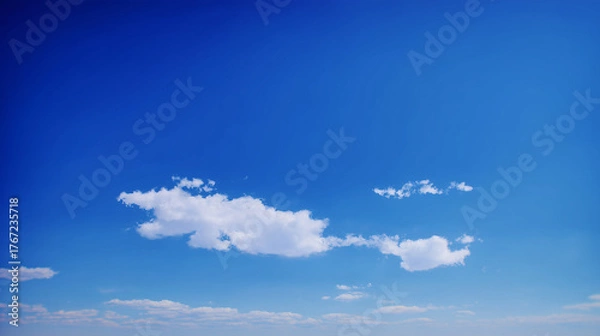 Fototapeta Sky Serenity: A pristine expanse of a vivid blue sky, dotted with a few fluffy clouds, creating a sense of peace and openness.