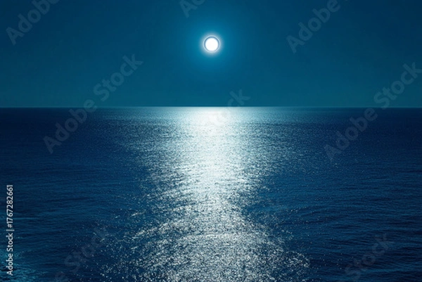 Fototapeta An eclipse casting an eerie shadow over the shimmering blue sea  
