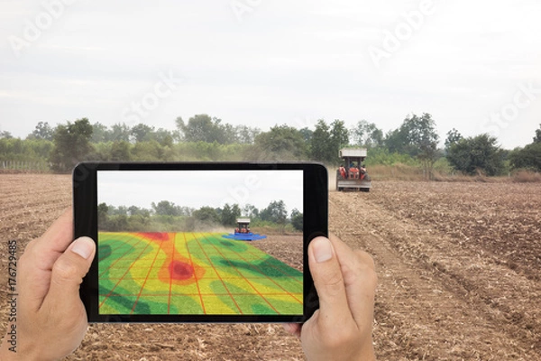 Fototapeta smart agriculture concept, farmer use tablet read infrared in tractor with high definition soil mapping while planting,conduct deep soil scan during a tillage pass include organic, ec,om,Nitrogen,seed