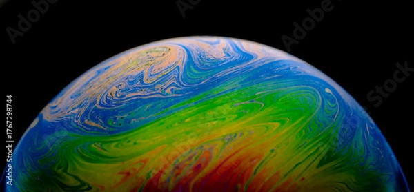 Fototapeta Closed up rainbow dynamic swirls wave and art patterns in bubbles isolated on black background. Abstract background. 