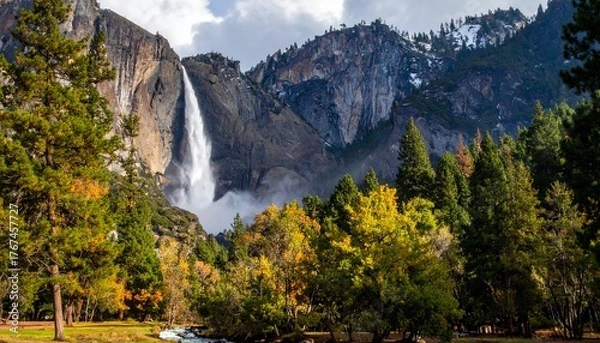 Fototapeta Beautiful waterfall in mountain valley surrounded by colorful autumn forest