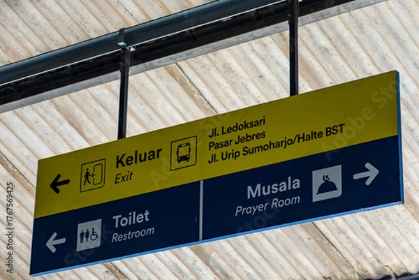 Fototapeta Indonesian Directional Signboard with Exit, Toilet, and Prayer Room Information at Public Terminal