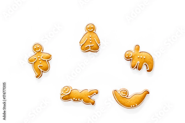 Fototapeta Gingerbread cookies in shape of yoga asanas on white background top view copyspace