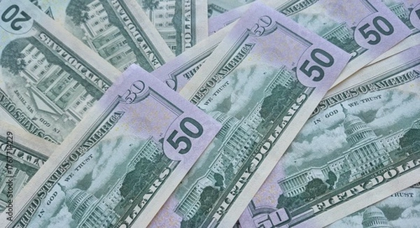 Fototapeta American or US dollars in form of a bunch of fifty and twenty dollar bills - money in the USA