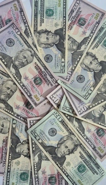 Fototapeta American or US dollars in form of a bunch of fifty and twenty dollar bills - money in the USA