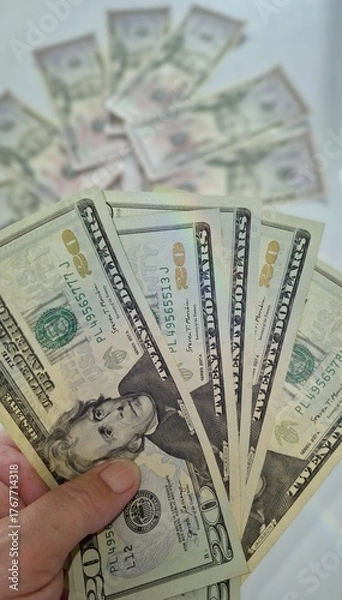 Fototapeta American or US dollars in form of a bunch of fifty and twenty dollar bills - money in the USA