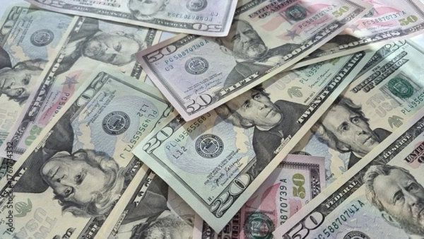 Fototapeta American or US dollars in form of a bunch of fifty and twenty dollar bills - money in the USA
