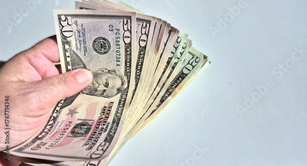 Fototapeta American or US dollars in form of a bunch of fifty and twenty dollar bills - money in the USA