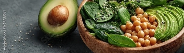 Fototapeta Minimal topdown view of lowglycemic salad bowl with avocado, spinach, and chickpeas, vibrant colors, wellness focus