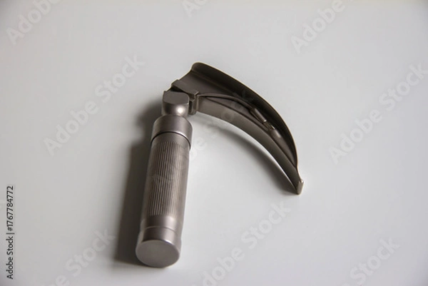 Obraz Laryngoscope lying on a white table. Horizontal shot.