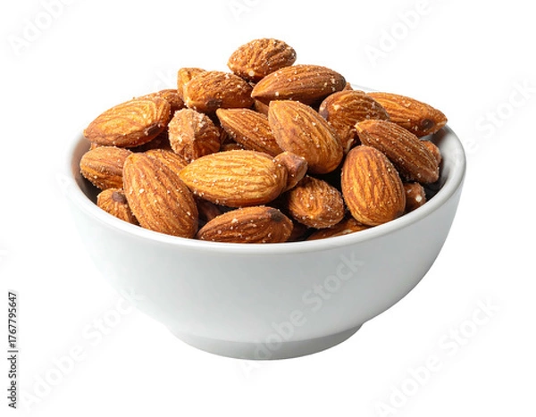 Fototapeta Bowl overflowing with glistening, salted almonds against a dark background