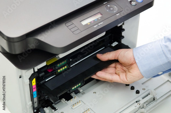 Obraz Man replacing toner in laser printer