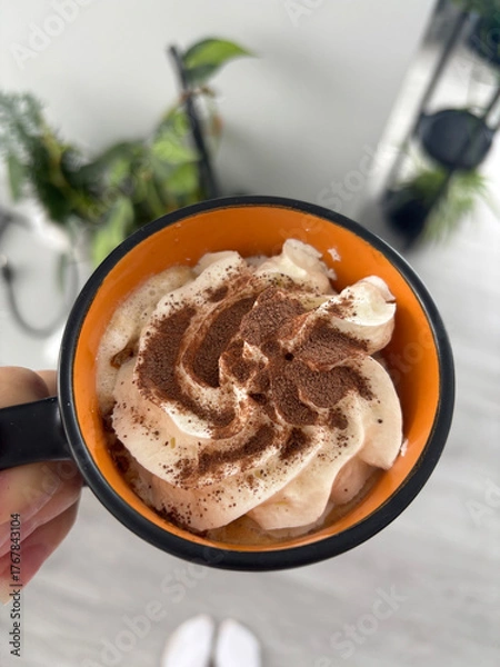 Obraz Cappuccino with whipped cream in cozy cafe setting