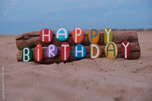 Obraz Creative Happy Birthday message composed with hand painted multi colored stone letters on the beach