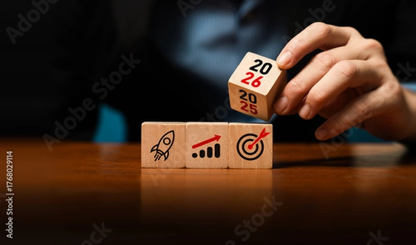 Fototapeta Business planning and growth strategy concept with wooden blocks showing rocket launch, financial chart, target, year 2025 to 2026, symbolizing success, future goals, investment, corporate development