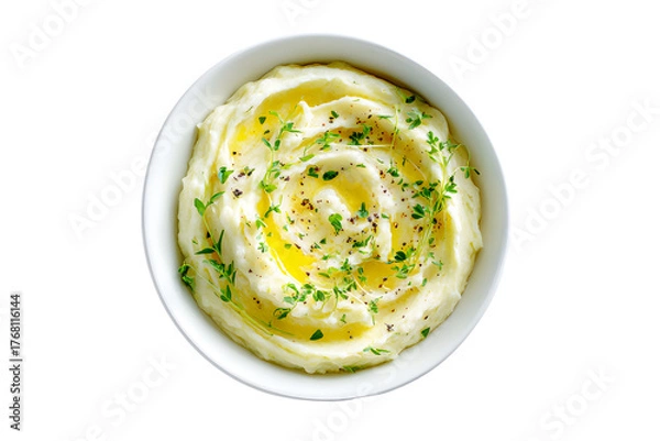 Fototapeta Top-down view of creamy mashed potatoes served in elegant bowl white ceramic beautifully. Isolated on cut out PNG or transparent background. Garnished with swirl of butter and fresh herbs.