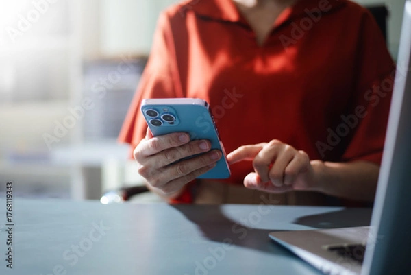 Fototapeta Business professional using smartphone for digital communication, apps, and online connection.