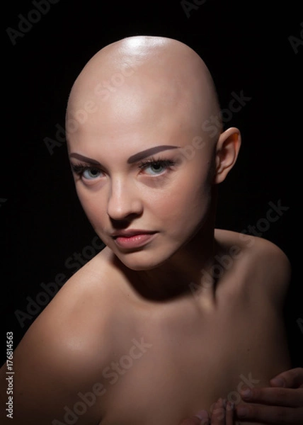 Obraz Portrait of a bald girl on a black background.